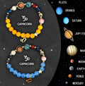 Set of twelve natural stone beaded bracelets for each zodiac sign laid out flat.