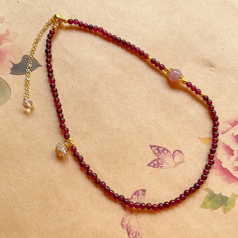 Women's double ring bracelet with natural red garnet beads and adjustable clasp.