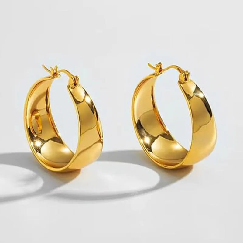 Widened curved stainless steel earrings in steel or gold colour, 25mm or 30mm size