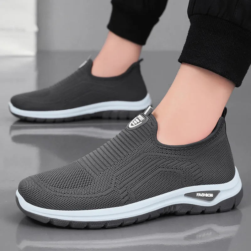 Men's grey breathable casual slip-on shoes with mesh detailing and a round toe.