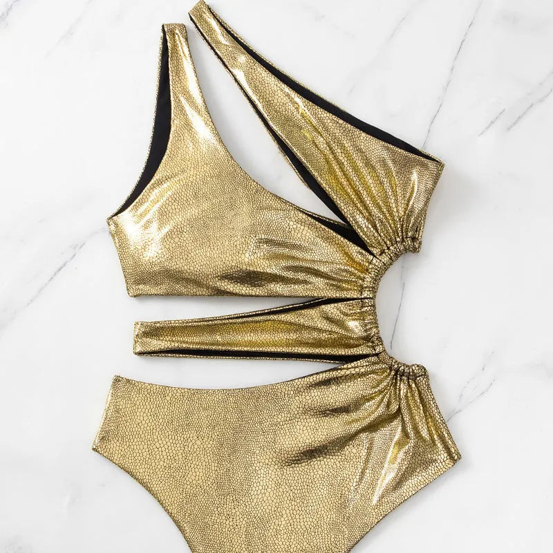 Gold women's one-piece swimsuit with backless design and spandex construction for swimming