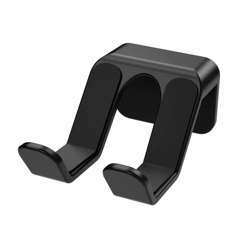 Black non-perforated wall rack holding two game controllers, mounted with adhesive.