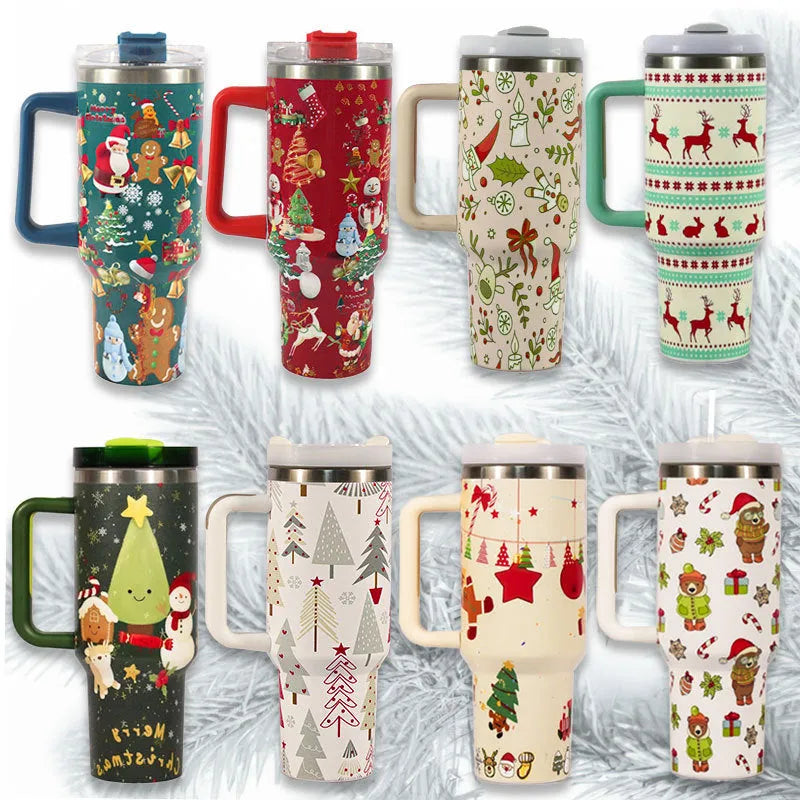 Red Christmas pattern stainless steel travel tumbler with handle, straw, and lid on a table.