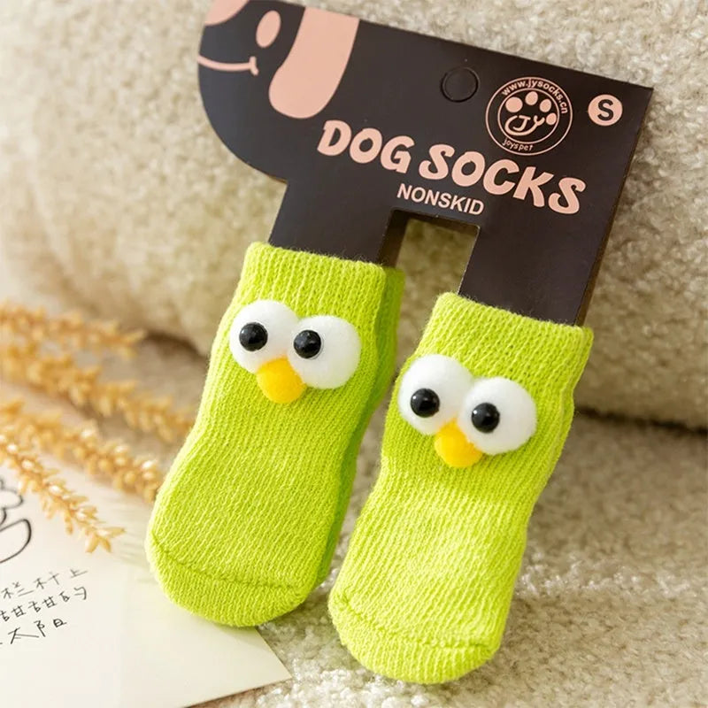 Dog all-season universal cotton socks with cute big eyes, anti-slip sole, green colour, side view on wooden floor