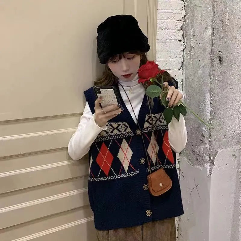 Khaki diamond plaid sleeveless cardigan on a hanger, showing loose fit and open front.