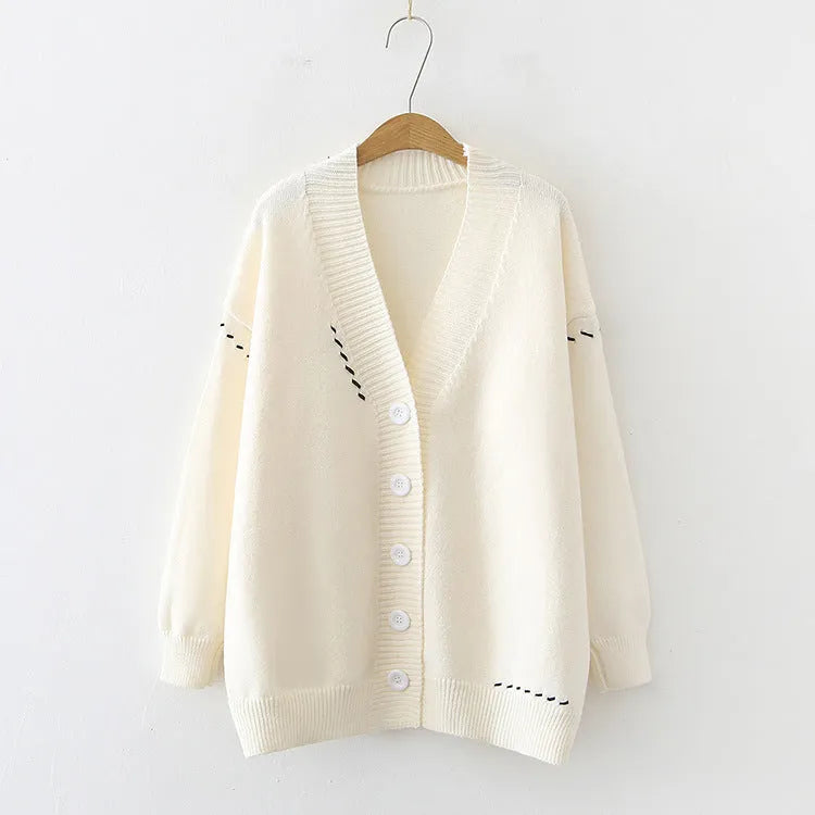 Women's loose fit long sleeve knitted cardigan coat in black or white.