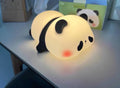 Cute silicone night light sheep cartoon bedroom lamp with warm light, rechargeable, on a bedside table