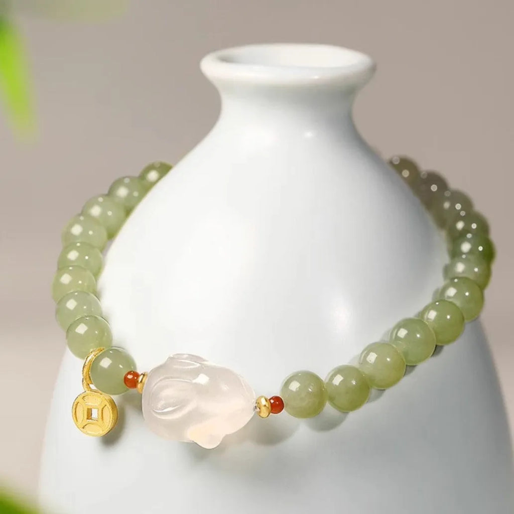 Handmade Hetian jade rabbit bracelet for women in glass with sweet rabbit charm on wrist.