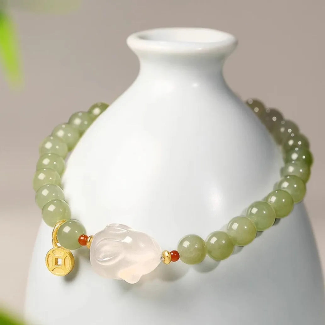 Handmade Hetian jade rabbit bracelet for women in glass with sweet rabbit charm on wrist.