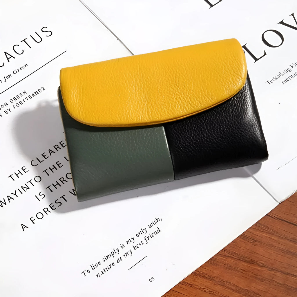 Women's short wallet with soft leather texture and stitching detail in solid colour, urban minimalist style