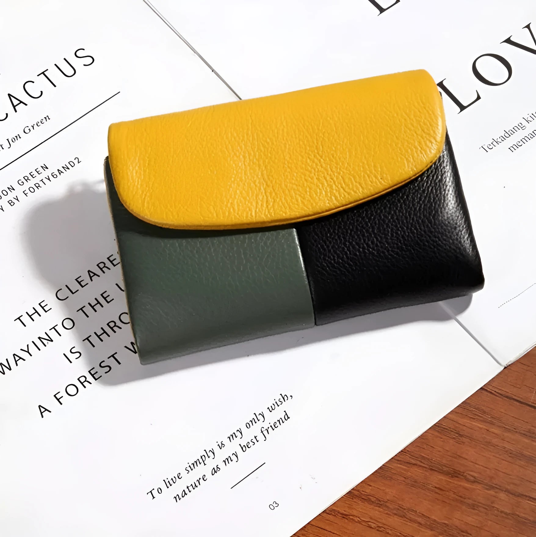 Women's short wallet with soft leather texture and stitching detail in solid colour, urban minimalist style