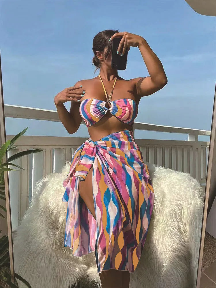 Yellow green women's three-piece bikini set with printed skirt on a hanger.