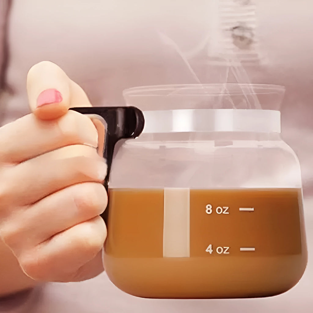 Transparent borosilicate glass coffee maker with a black silicone cover for pour-over brewing.