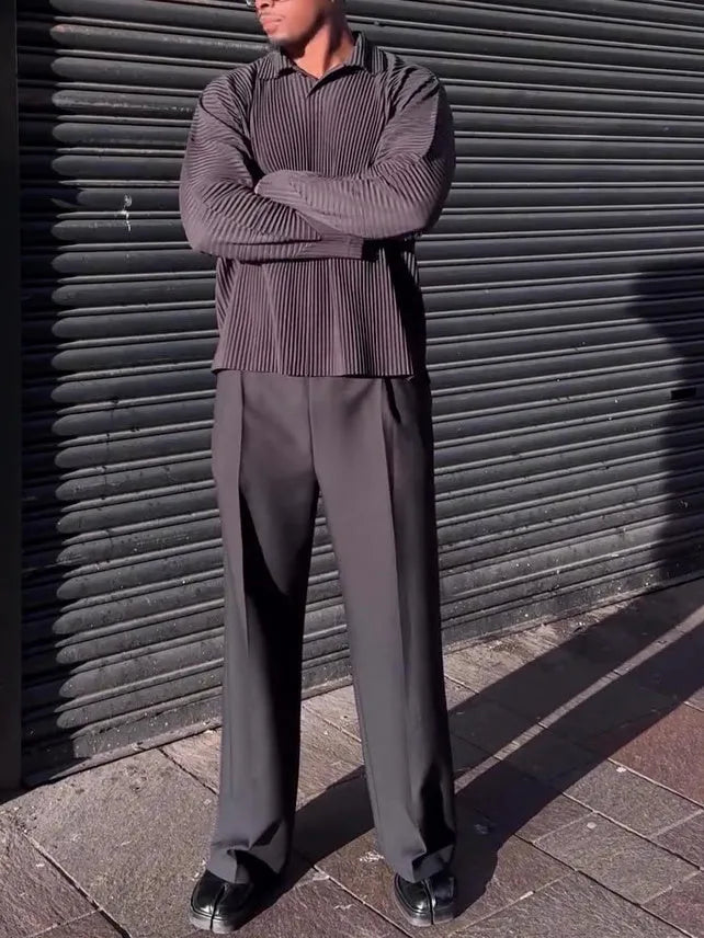Men's black long-sleeved casual top with a pleated design detail.