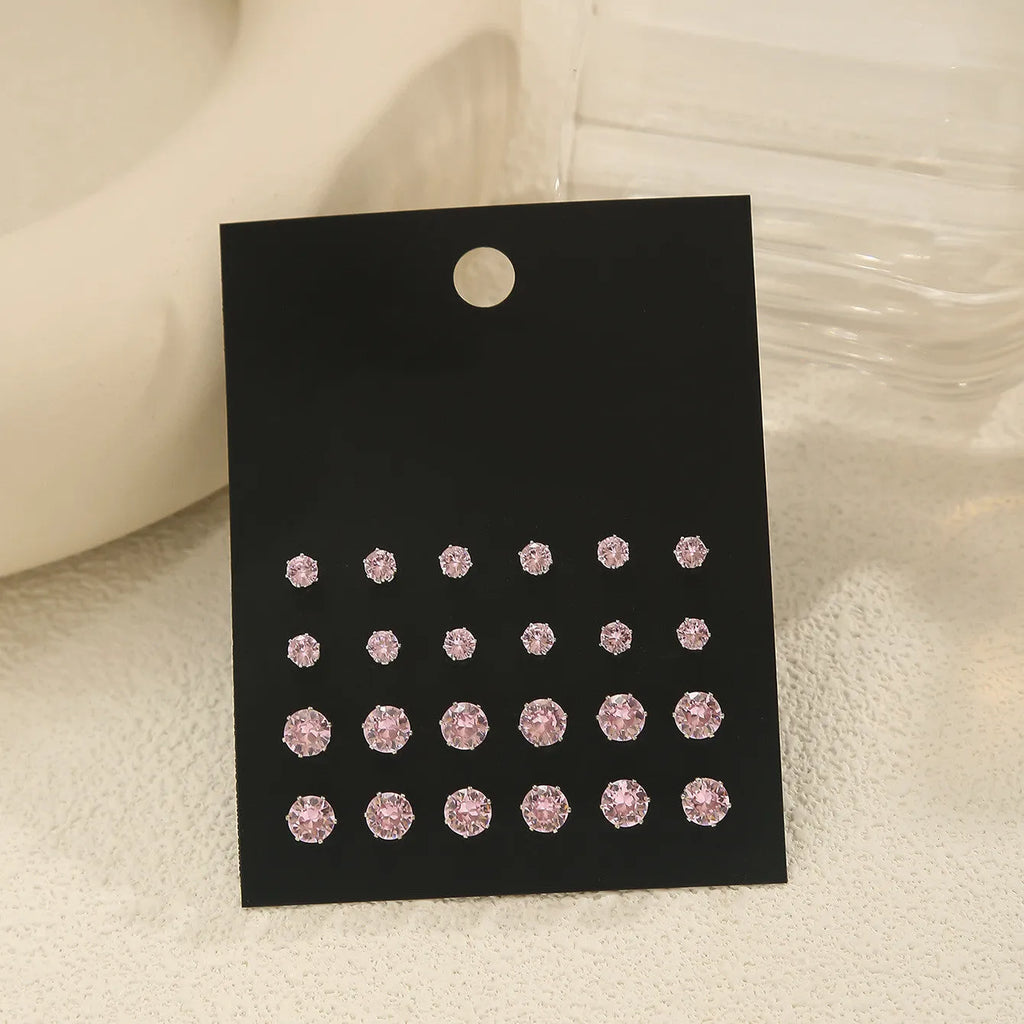 Pink round women's earrings set with 12 pairs of alloy electroplated geometric studs on display