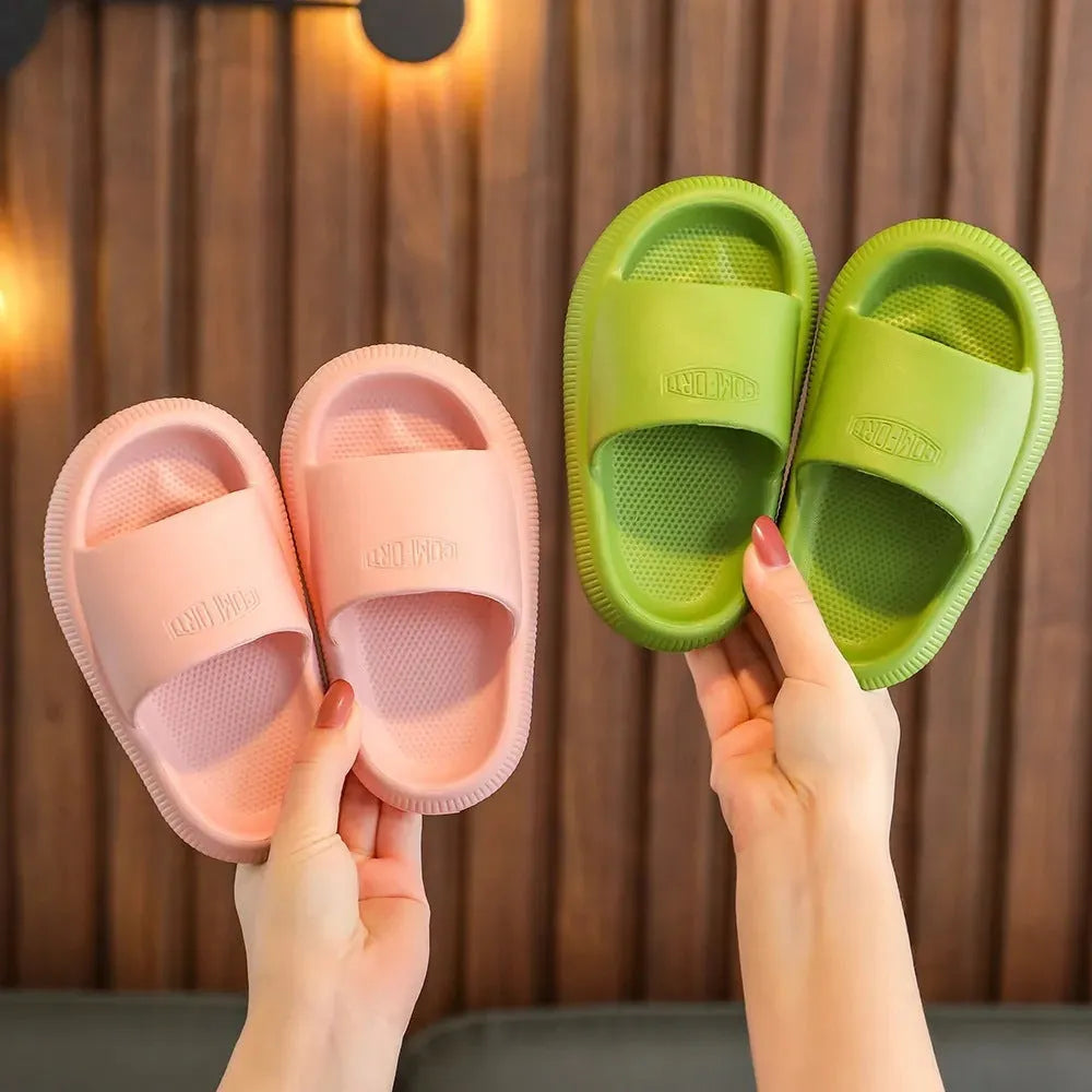 Children's colourful EVA slippers with a non-slip sole, shown in blue, green, orange, pink, and yellow.
