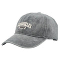 Personalised retro-style peaked cap with embroidered letters on distressed fabric in beige colour.