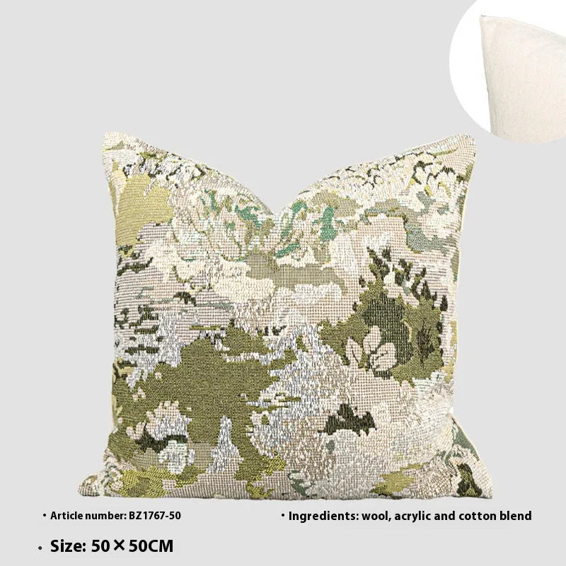 Green antique French style floral pattern wool blend decorative pillow on a sofa.