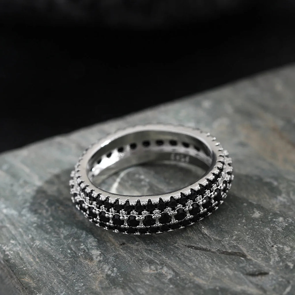 Geometric triangle zircon inlay ring in white gold, yellow gold, and white and black finishes on a copper band.