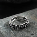 Geometric triangle zircon inlay ring in white gold, yellow gold, and white and black finishes on a copper band.