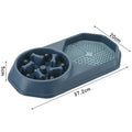 Blue slow feeder dog bowl with maze pattern for anti-gulping, non-slip base, on a wooden floor.