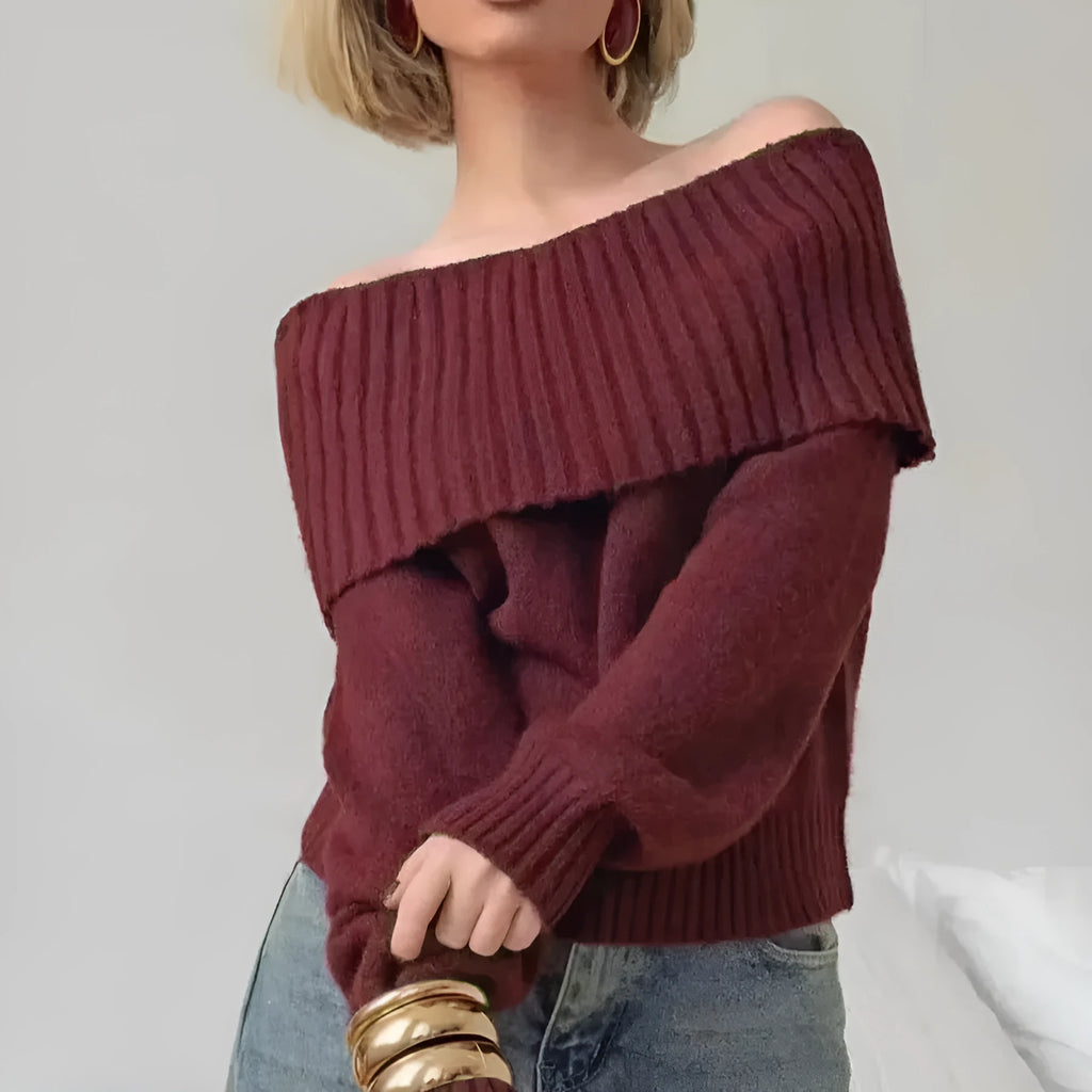 Grey off-the-shoulder acrylic sweater with a textured 3D pattern on a hanger.