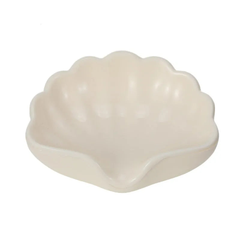 Shell-shaped plastic soap dish in pearl white or cherry blossom pink for bathroom use