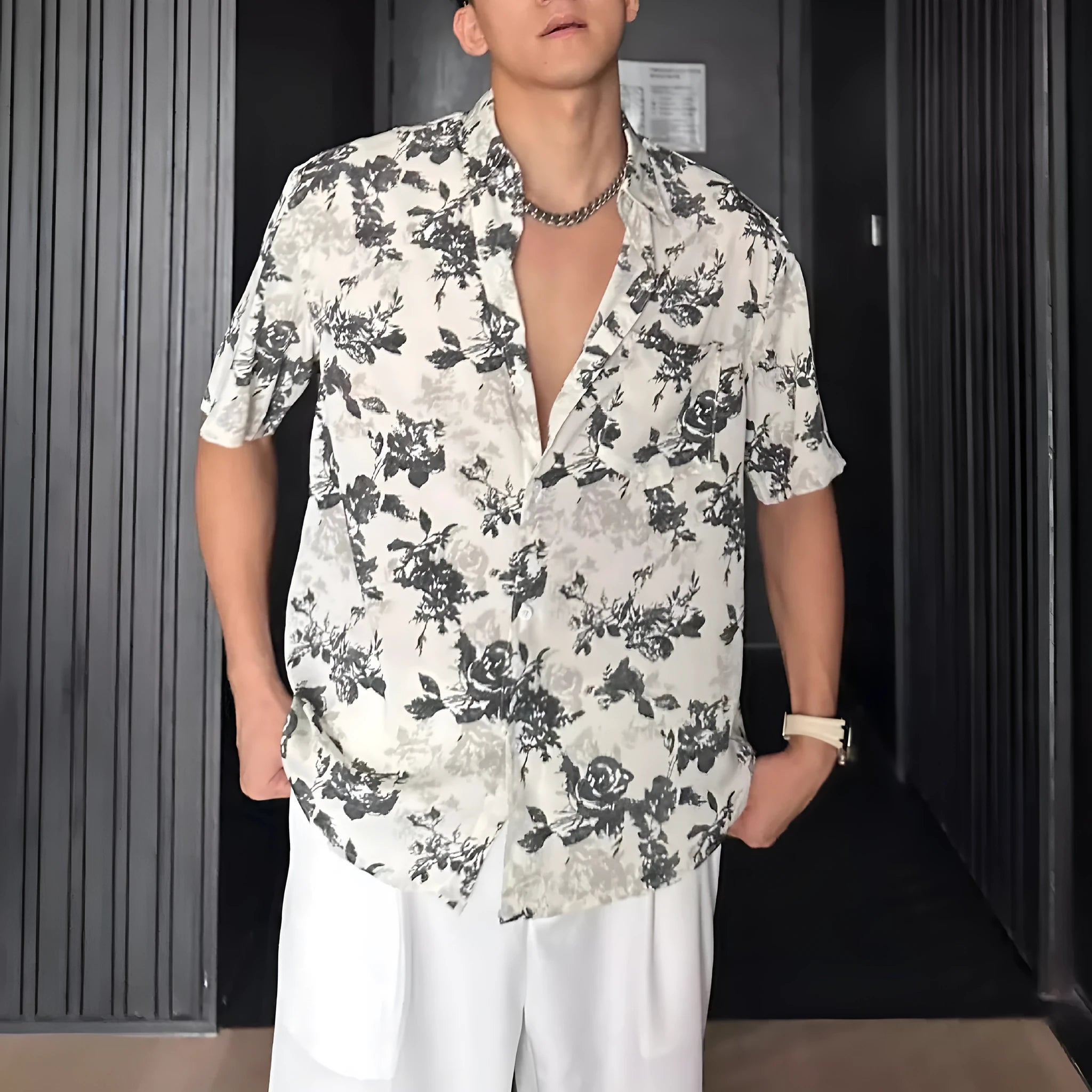 Men's loose-fit black short sleeve shirt with a white floral print pattern.