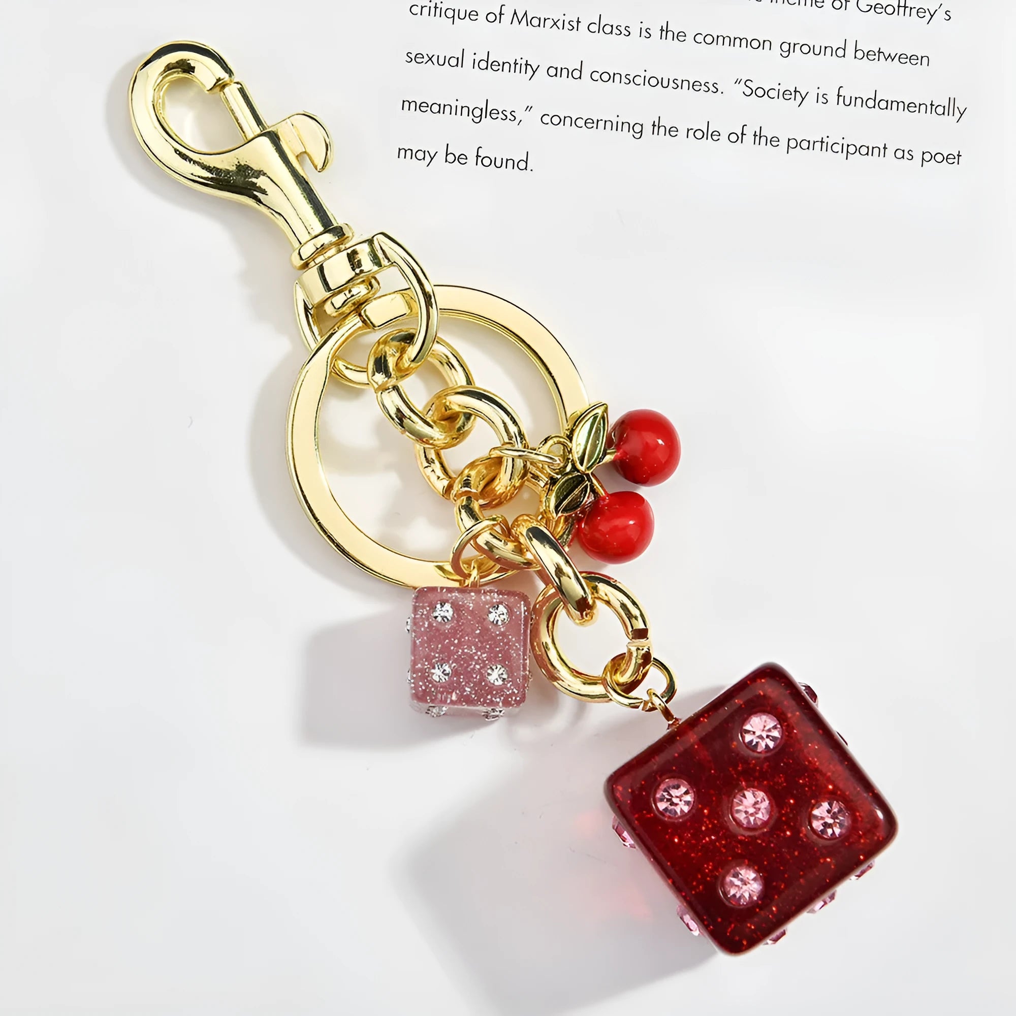 Square metal keychain pendant with a vintage two-tone cherry dice pattern.