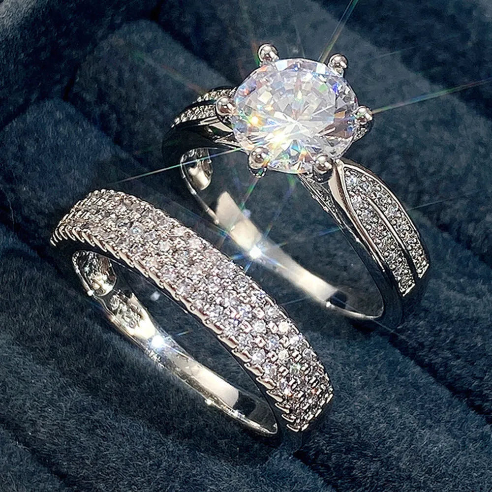 Geometric white gold colour alloy wedding ring on a finger, showing its round design.
