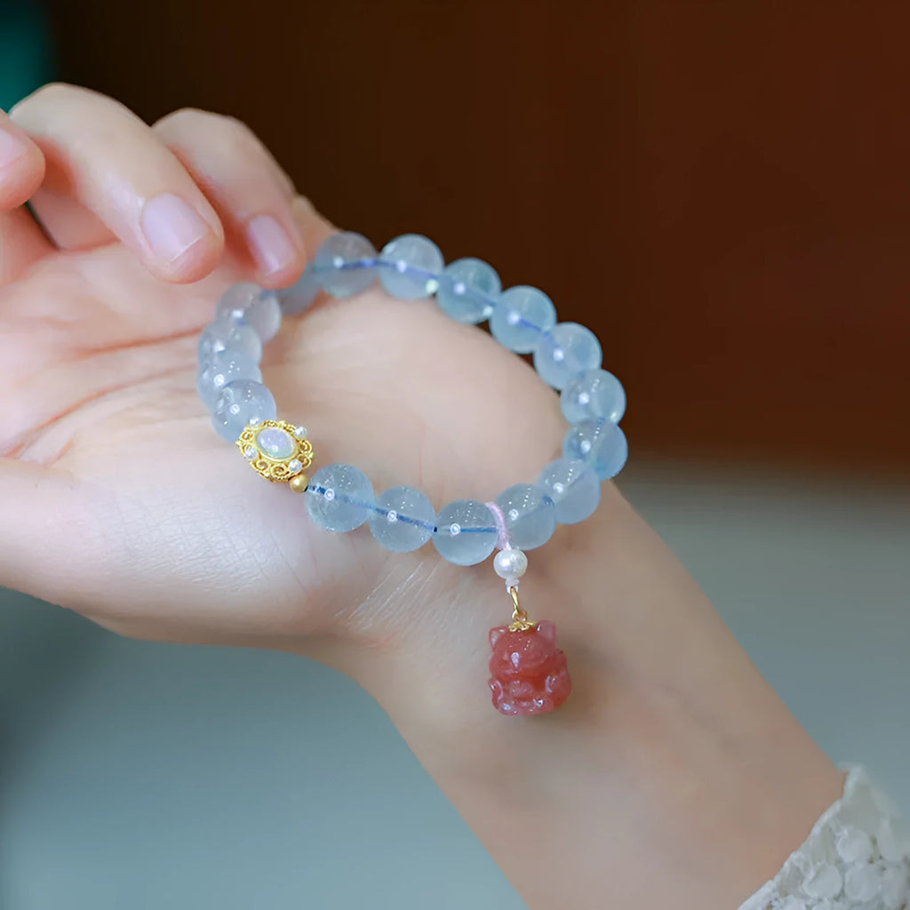 DIY aquamarine bracelet kit with Chinese Fengjiu fox design and pink crystals.