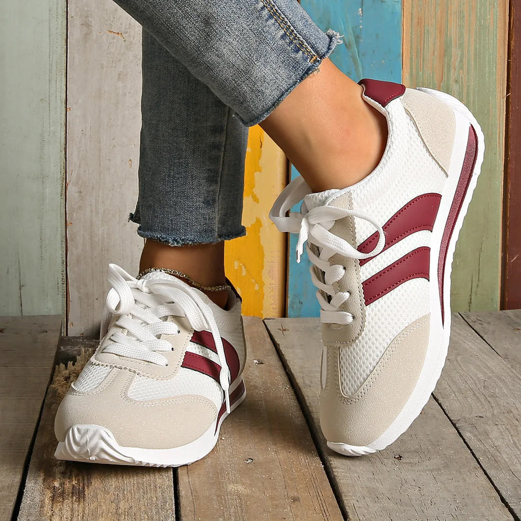 Wine red Cortez-style casual sneakers with a cross-strap detail and mesh lining.