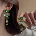 A pair of geometric-shaped green gradient earrings with zircon stones and a tassel, in a Chinese style.