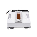 White square window cleaning robot with water spray nozzles on a glass window pane.