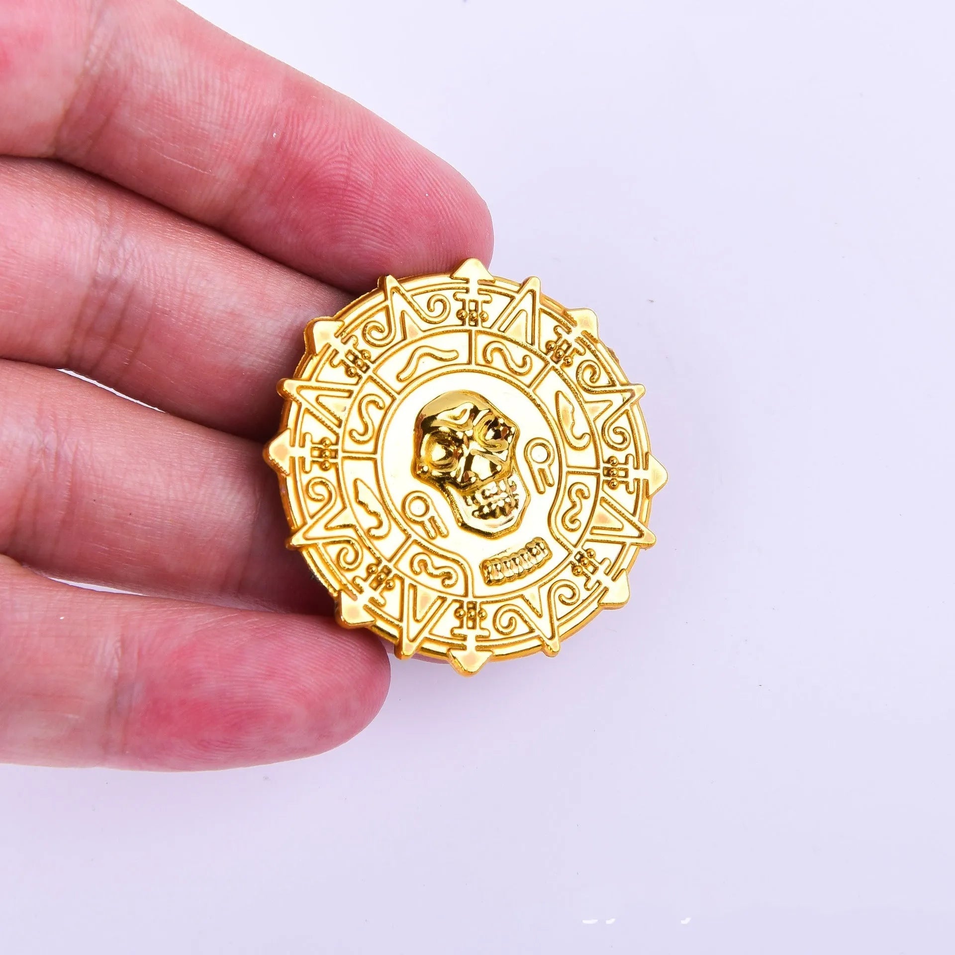 Plastic pirate gold coin toy with pointed tip measuring 3.6cm diameter
