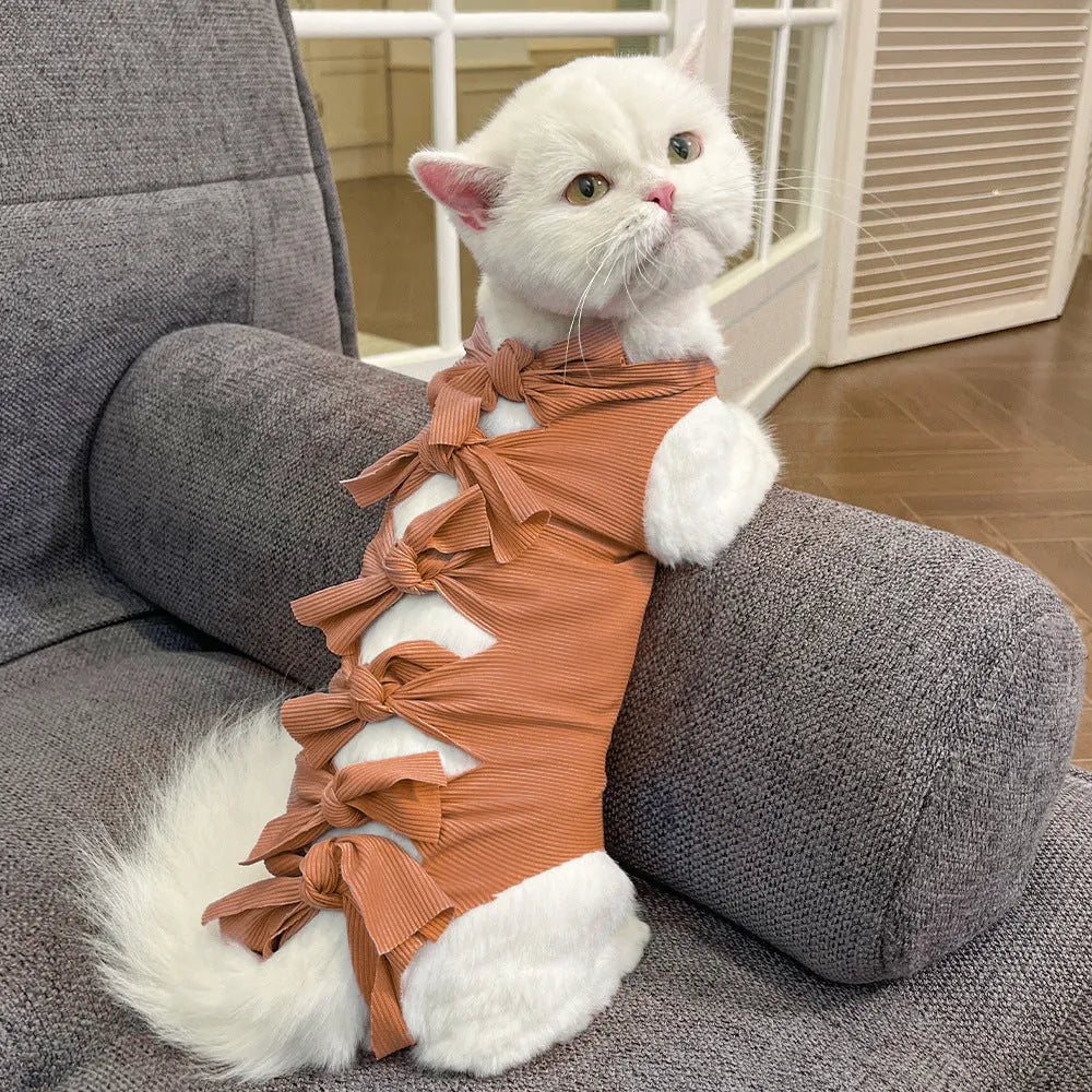 Adjustable lace-up polyester recovery suit for a cat after spaying surgery, shown in blue.