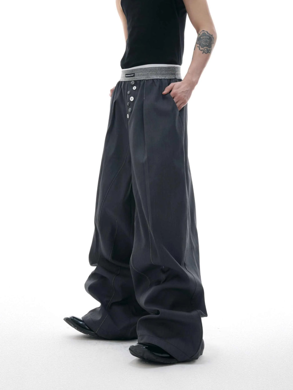 High-waist straight-leg trousers with a button detail on the leg in black or grey.