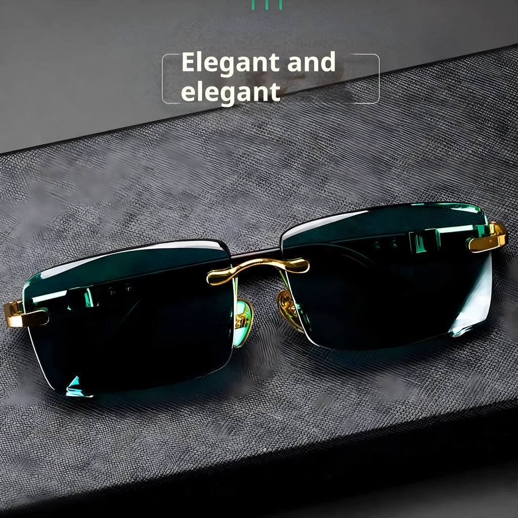 Dark green crystal frameless sunglasses with a case and cleaning cloth on a table.