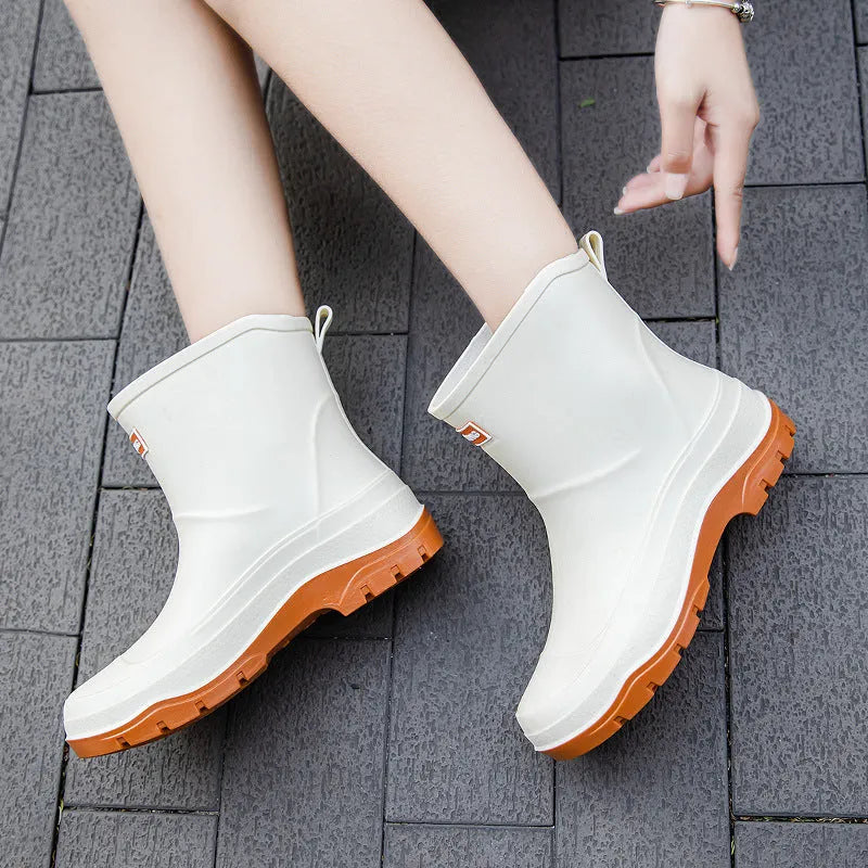 Women's short waterproof rubber shoe with non-slip sole in white colour on a flat heel.