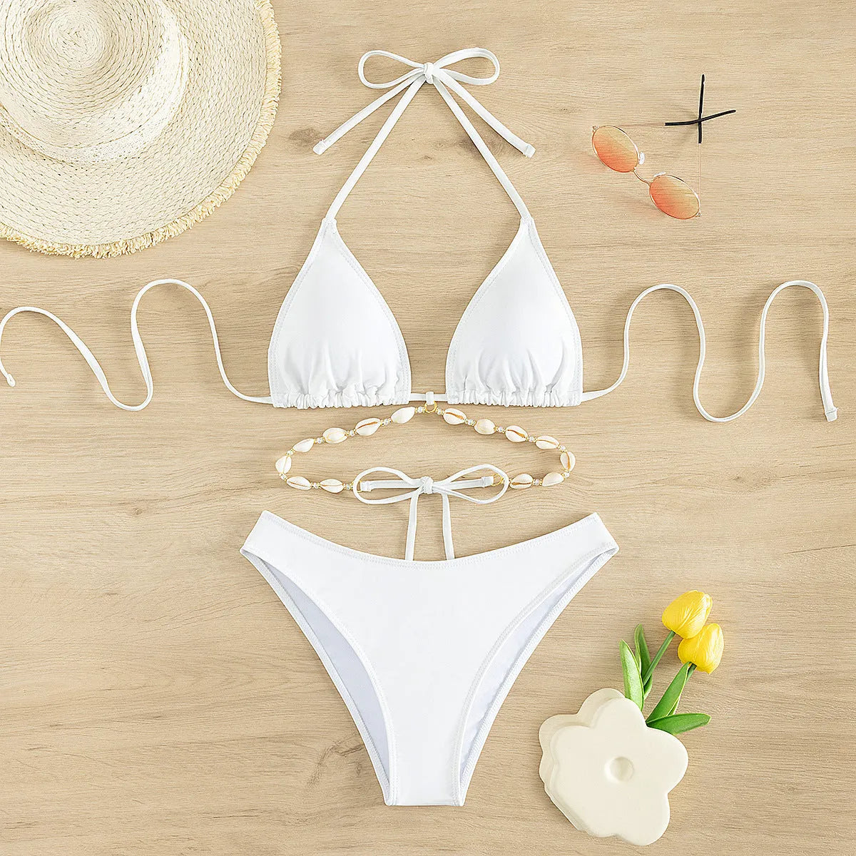 Women's black and white halter neck bikini with lace-up back.