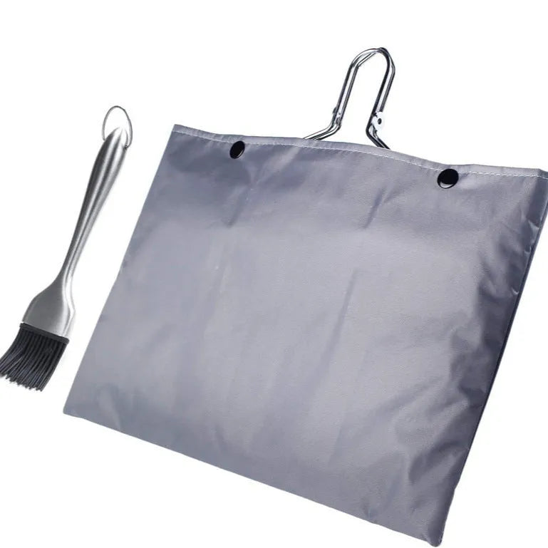 Square stainless steel folding barbecue mesh basket with a grill brush on a grey background.