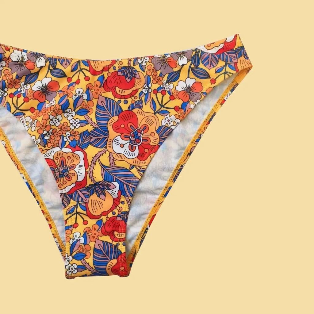 Plus size women's floral print bikini swimsuit with strap design on white background