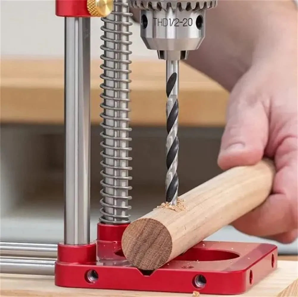 Alloy steel woodworking drill locator with red polymer handle on a wooden surface