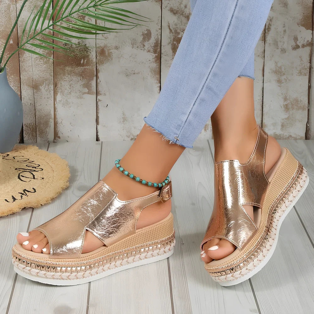 Women's gold fish mouth buckle wedges with hollow sides and 7 cm rubber heel on white background