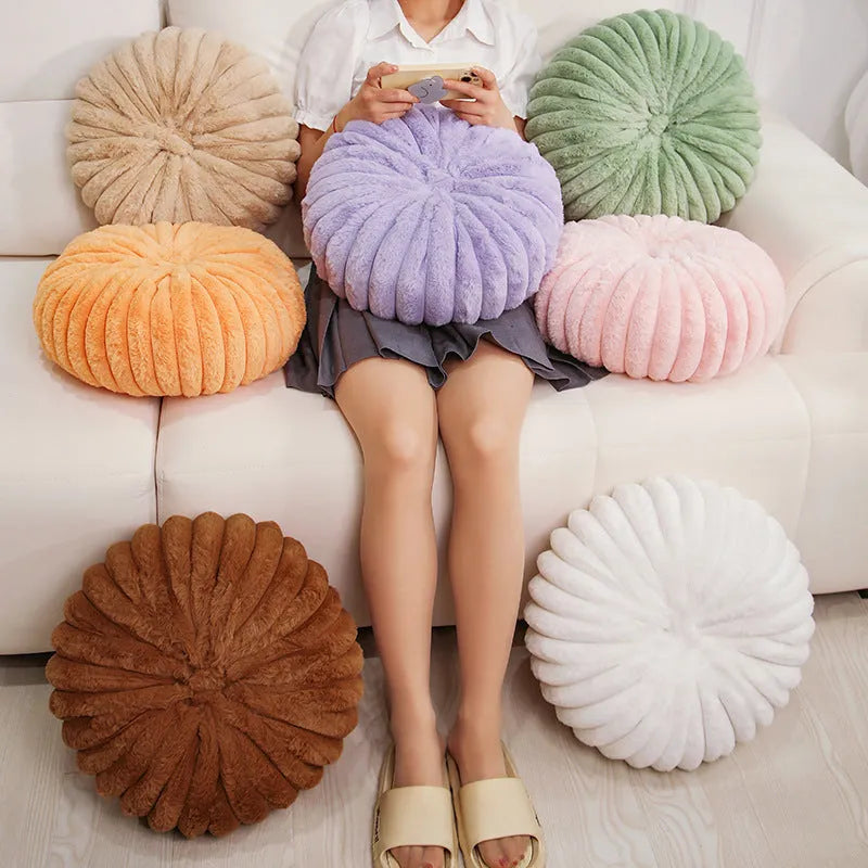 Pumpkin shaped seat cushion in khaki with short plush cover, 35x35x15cm, next to a window