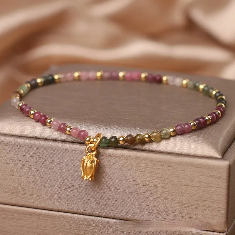 Green tourmaline floral bead anklet with adjustable chain on woman's ankle