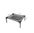 Black portable outdoor dog bed with steel frame and removable Oxford cloth cover, shown on grass.
