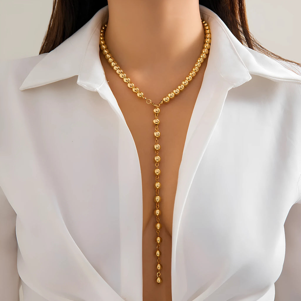 Round beads imitation pearl necklace on display showing gold colour metal chain