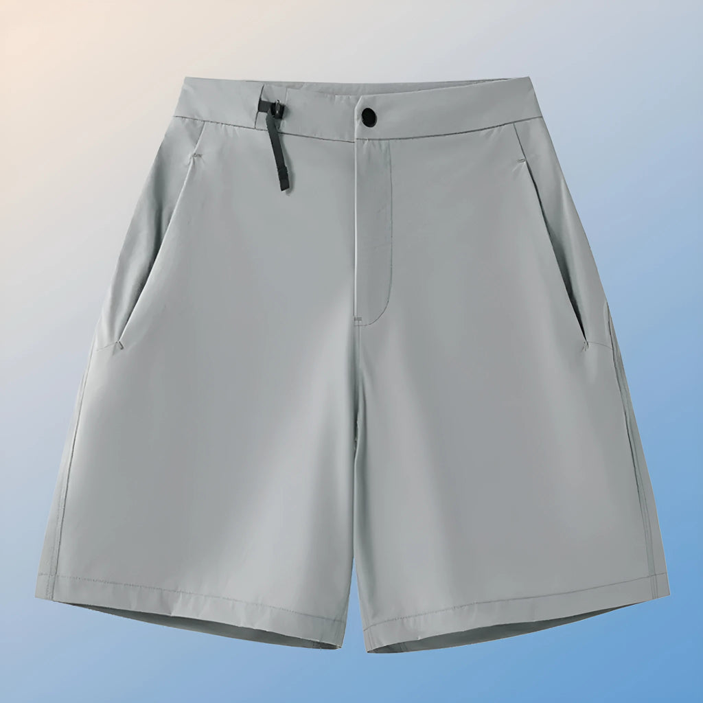 Man wearing khaki quick-dry sports shorts with four-way stretch on a running track.