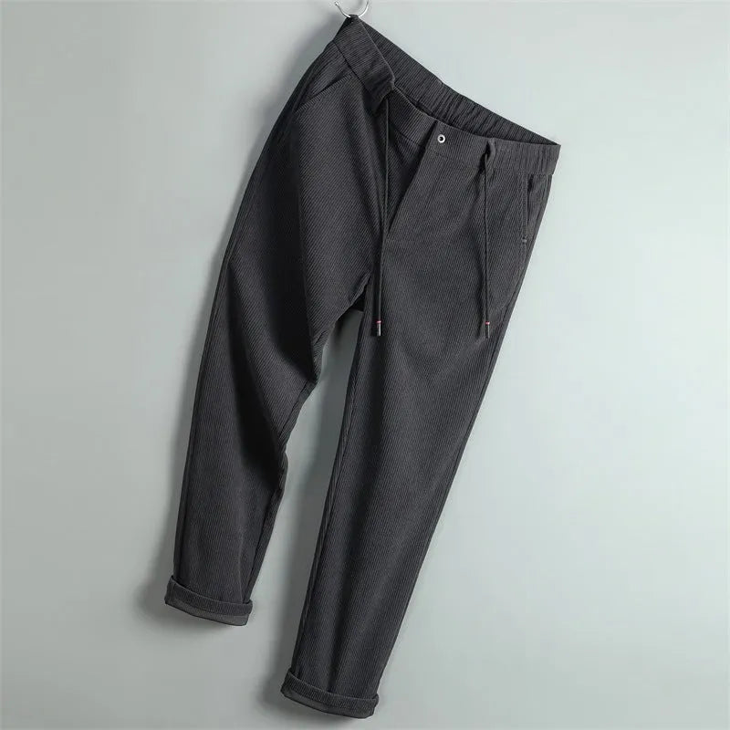 Men's casual striped polyester trousers in black, size 30, front view